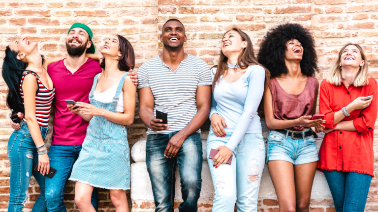 life insurance for millennials a diverse group of millennials againts the wall laughing.