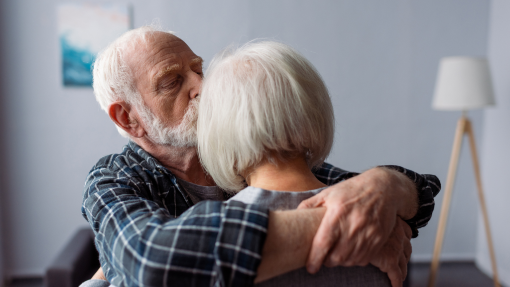 an elderly man holding his wife with Alzheimers. financial lifeline with living Benefits
