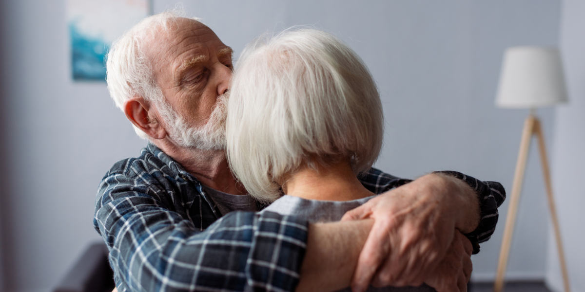 an elderly man holding his wife with Alzheimers. financial lifeline with living Benefits